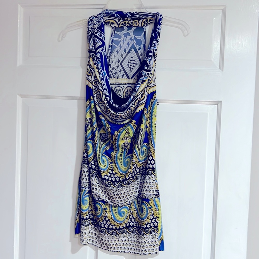 T-back top with band at bottom. Draped bodice super cute. Fitted.